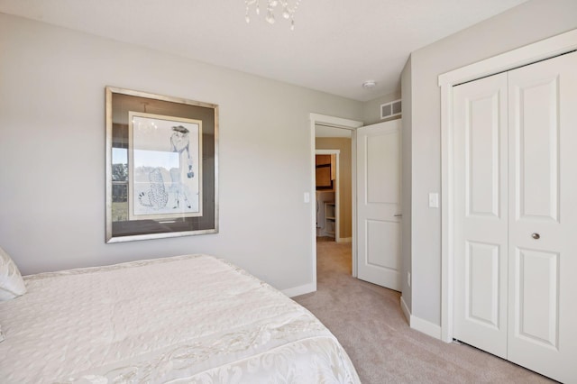 carpeted bedroom featuring baseboards, visible vents, and a closet
