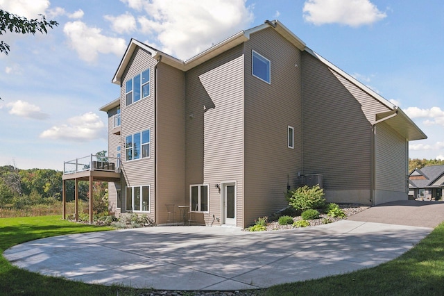 rear view of property with a patio and a yard
