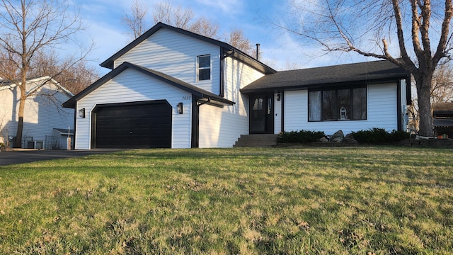 tri-level home with driveway and a front yard