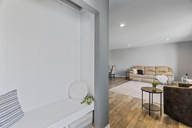living area with baseboards, recessed lighting, and wood finished floors