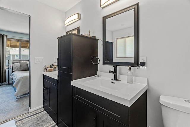 bathroom featuring vanity, toilet, and ensuite bath