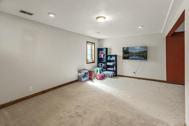 rec room featuring carpet flooring, baseboards, and visible vents