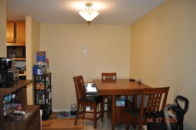 dining area featuring baseboards and wood finished floors