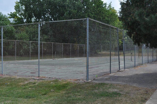 view of sport court featuring fence