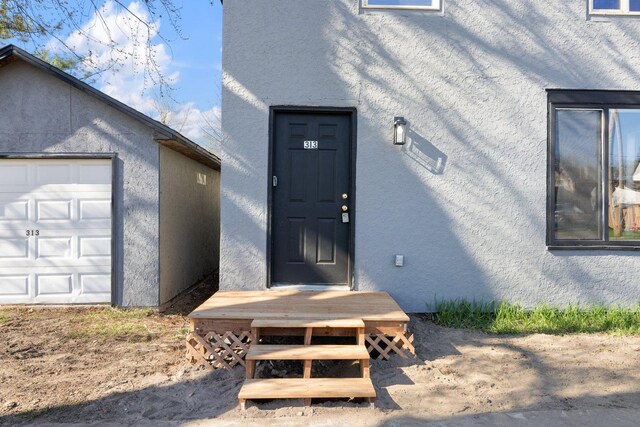 313 3rd St, Bovey, MN 55709 - property entrance with stucco siding