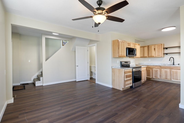 313 3rd St, Bovey, MN 55709 - kitchen featuring stainless steel appliances, light brown cabinetry, light countertops, a sink, and dark wood-style floors