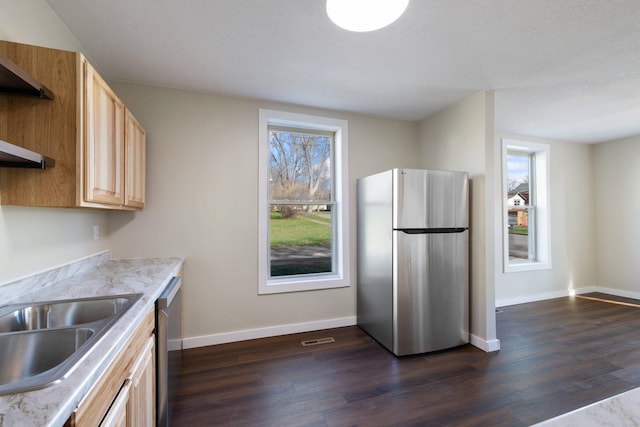 313 3rd St, Bovey, MN 55709 - kitchen featuring stainless steel appliances, dark wood-type flooring, light brown cabinetry, and light countertops