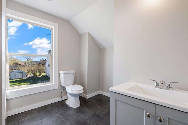 313 3rd St, Bovey, MN 55709 - half bath featuring toilet, vaulted ceiling, baseboards, and vanity