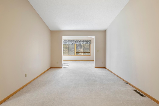 carpeted empty room with baseboards, baseboard heating, and visible vents