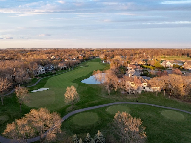 drone / aerial view featuring view of golf course and a residential view