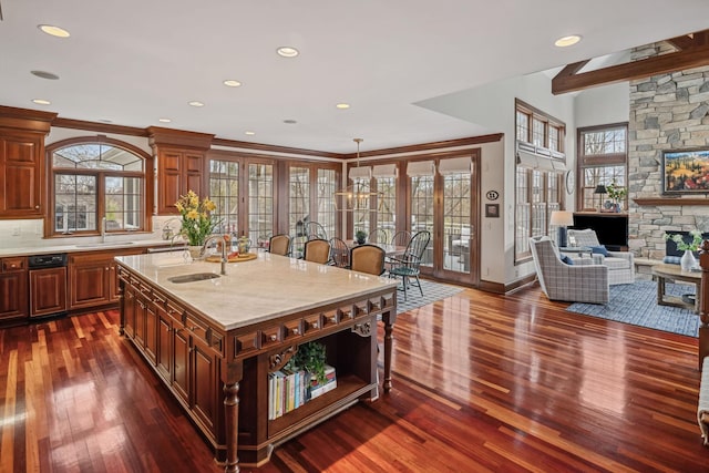 kitchen with dark wood-type flooring, a sink, backsplash, and open floor plan