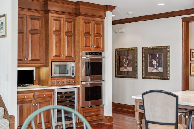 kitchen featuring dark wood-style flooring, beverage cooler, baseboards, light countertops, and appliances with stainless steel finishes