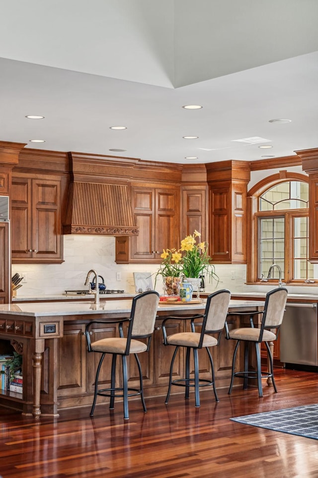 kitchen with light countertops, backsplash, stainless steel appliances, and recessed lighting