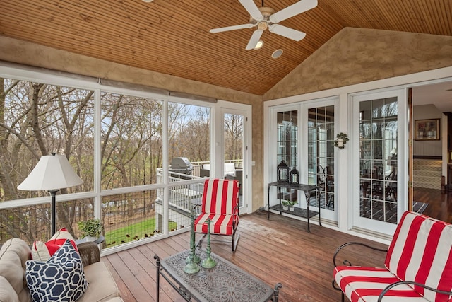 sunroom / solarium with a ceiling fan, wood ceiling, hardwood / wood-style floors, and high vaulted ceiling