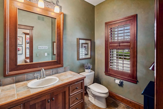 bathroom with visible vents, toilet, and vanity