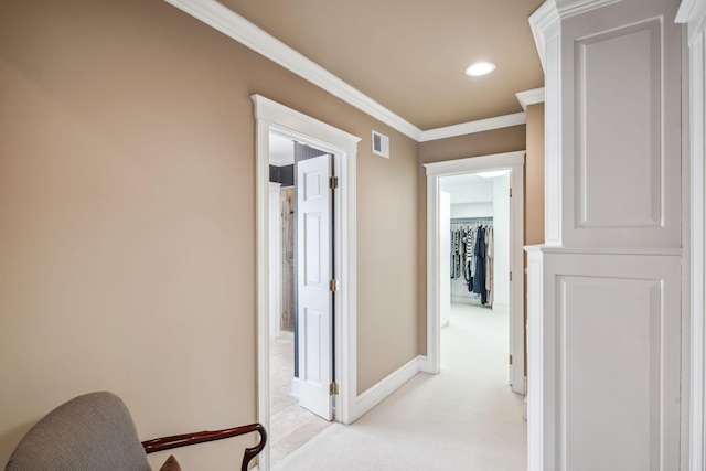 hallway with visible vents, ornamental molding, light carpet, baseboards, and recessed lighting
