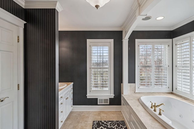bathroom with crown molding, visible vents, vanity, baseboards, and a whirlpool tub