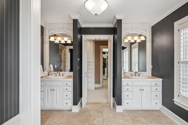 bathroom featuring a sink, two vanities, and a notable chandelier