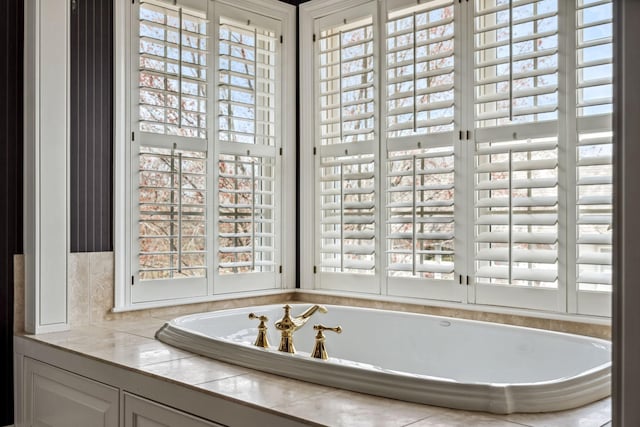 bathroom with a healthy amount of sunlight and a garden tub