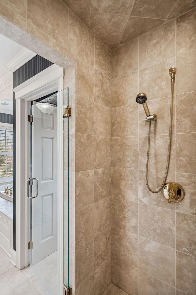bathroom featuring a shower stall, ornamental molding, and tile patterned flooring