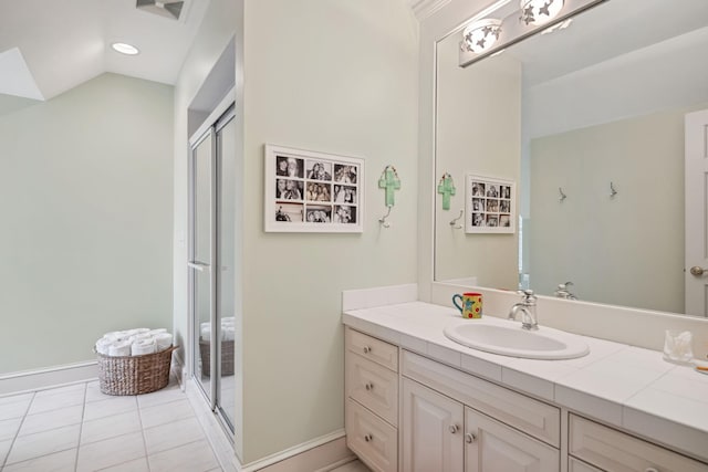full bathroom with baseboards, vanity, tile patterned floors, and a shower stall