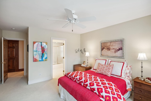 bedroom featuring baseboards, ceiling fan, carpet, and ensuite bath
