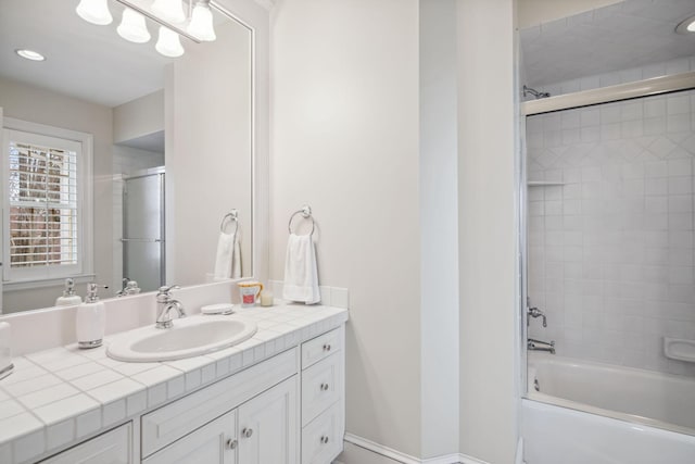 bathroom featuring vanity, recessed lighting, and shower / bath combination with glass door