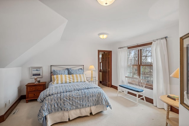 bedroom with carpet floors, baseboards, and visible vents