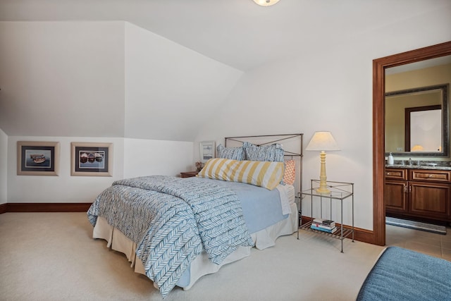 carpeted bedroom with baseboards and vaulted ceiling