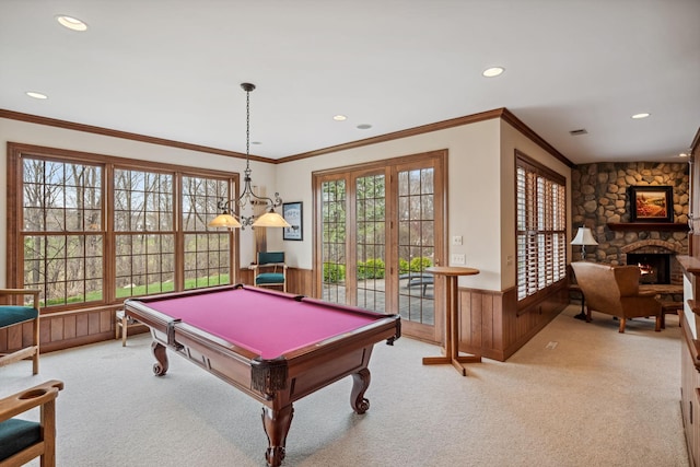 recreation room featuring plenty of natural light, wainscoting, and light colored carpet