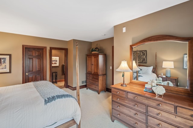 bedroom featuring baseboards, light colored carpet, and visible vents