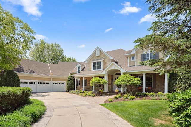 18371 Bearpath Trl, Eden Prairie, MN 55347 - view of front of property featuring covered porch, concrete driveway, a garage, a front lawn, and a shingled roof