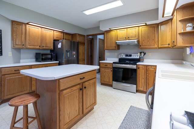 kitchen featuring stainless steel appliances, a sink, open shelves, under cabinet range hood, and light flooring