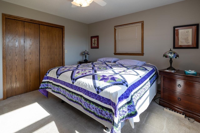 bedroom with carpet flooring, a closet, and a ceiling fan