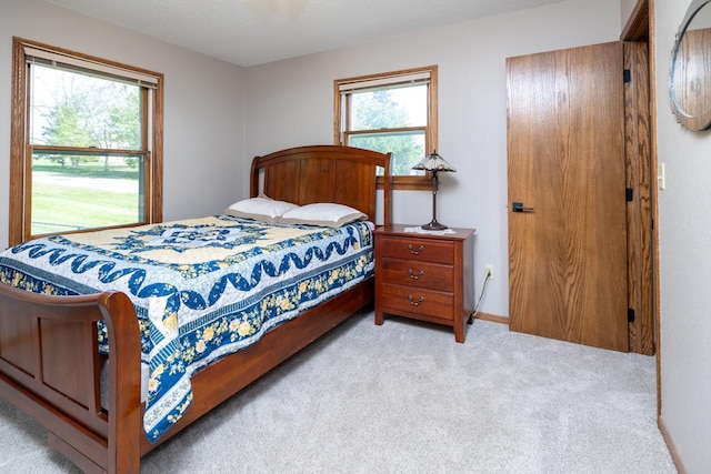 bedroom featuring light colored carpet