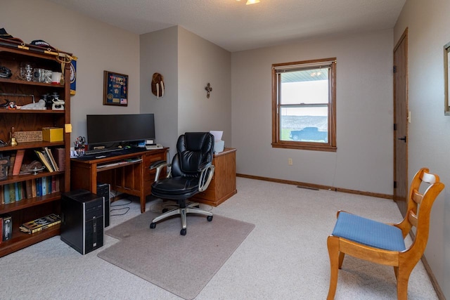 carpeted office featuring baseboards