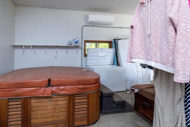 misc room with carpet and a wall unit AC