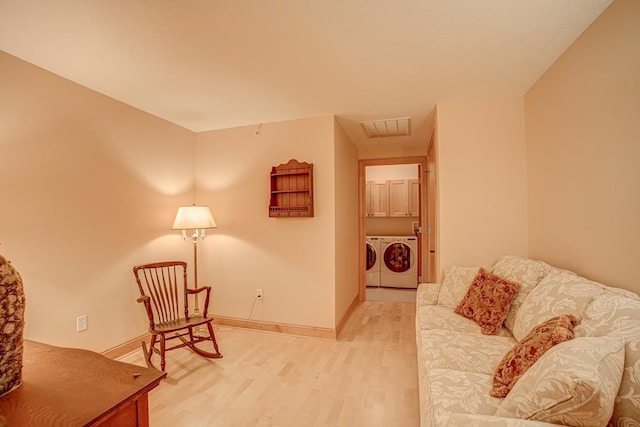 650 Main St N Unit 308, Stillwater, MN 55082 - sitting room featuring light wood-style floors, washing machine and dryer, and baseboards
