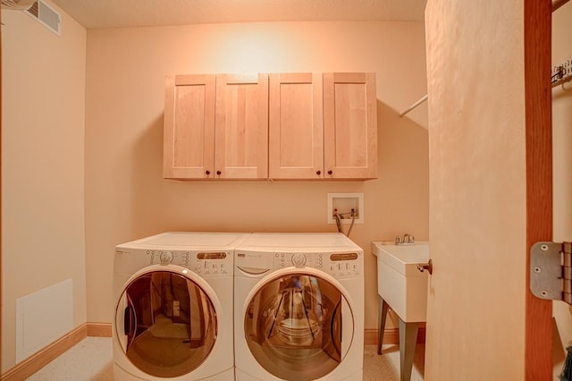650 Main St N Unit 308, Stillwater, MN 55082 - laundry area with cabinet space, washing machine and dryer, and baseboards