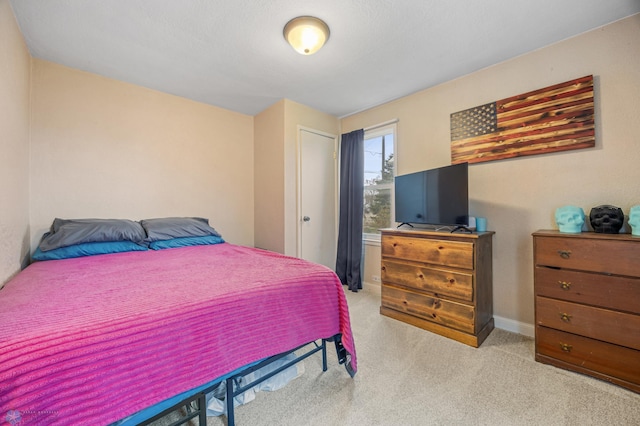carpeted bedroom with baseboards