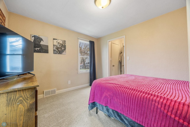 carpeted bedroom featuring visible vents and baseboards