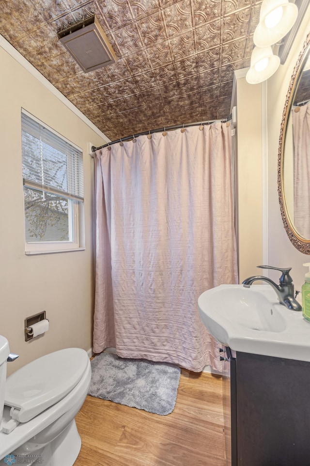 full bath with vanity, an ornate ceiling, toilet, wood finished floors, and ornamental molding