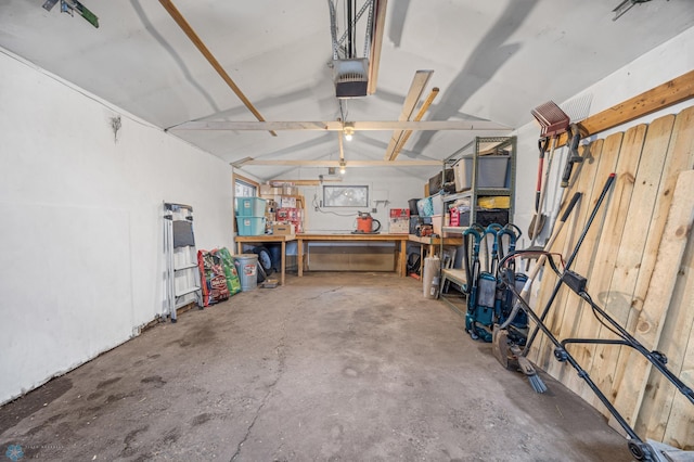 garage featuring a garage door opener and a workshop area