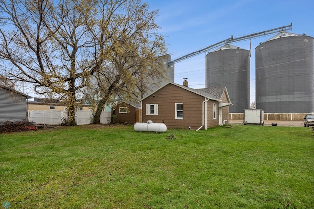 exterior space featuring fence, an outbuilding, and a shed