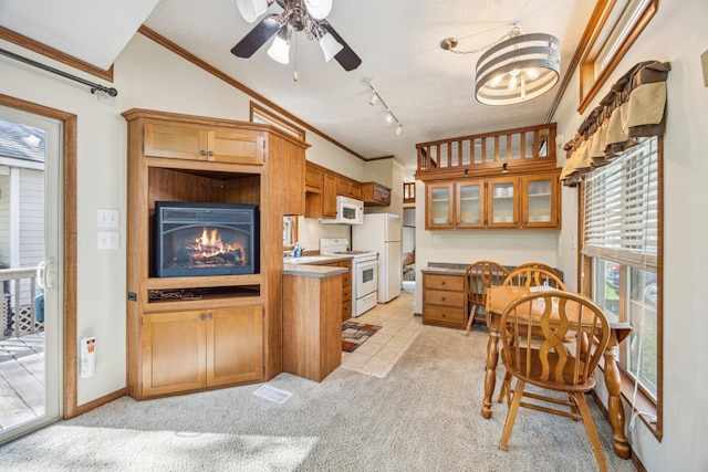 18096 Browns Lake Rd Unit 2, Eden Lake Twp, MN 56368 - kitchen with white appliances, crown molding, light carpet, ceiling fan, and brown cabinetry