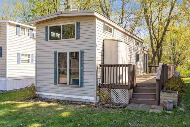 18096 Browns Lake Rd Unit 2, Eden Lake Twp, MN 56368 - back of house featuring a wooden deck and a lawn