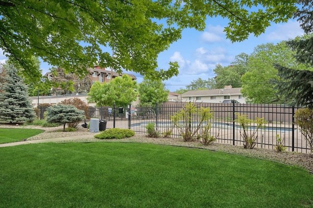view of yard featuring fence and a community pool