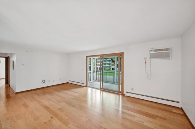 spare room with a baseboard radiator, light wood-style flooring, a baseboard heating unit, and a wall mounted air conditioner