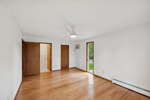 unfurnished bedroom featuring light wood-style floors, access to exterior, baseboards, a baseboard heating unit, and a wall mounted AC