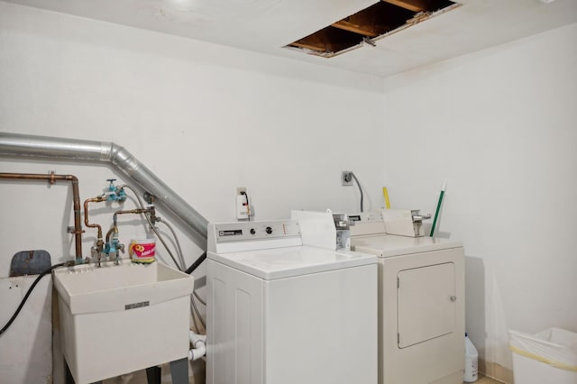 laundry room featuring separate washer and dryer and a sink
